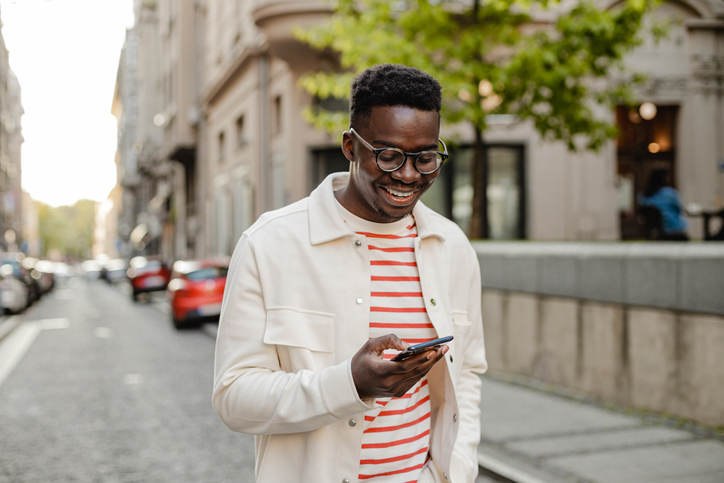 man uses a mobile phone on the go